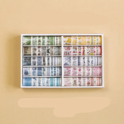Box of 100 antique character decorative paper tape rolls in assorted colours and widths for accounting and crafts.