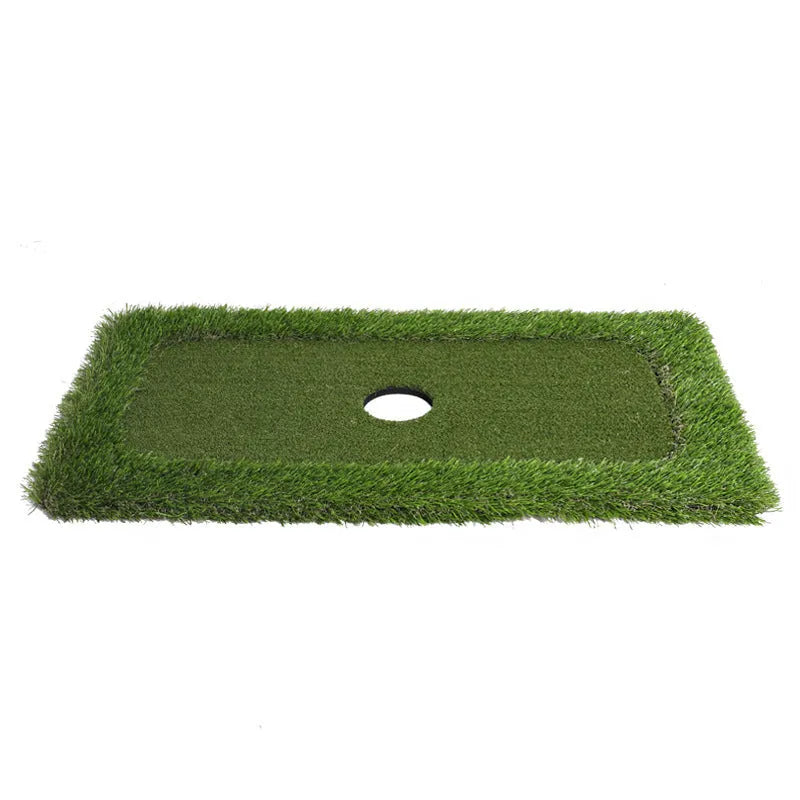 Green golf training mat on floor showing artificial grass surface and thick EVA foam base edge.