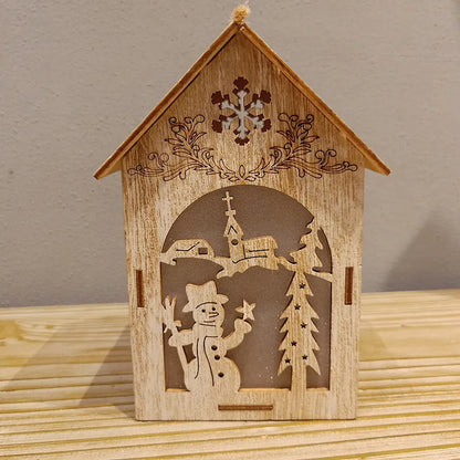 Three wooden Christmas house decorations: a small bell, a Santa Claus house, and a snowman house on a festive backdrop.