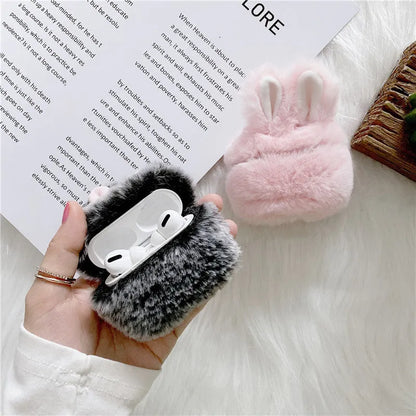 Pink silicone AirPods case cover with raised rabbit ears, placed next to grey version