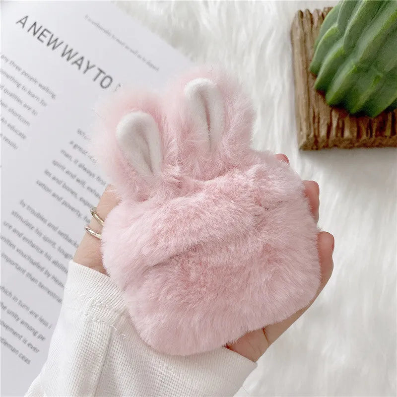 Pink silicone AirPods case cover with raised rabbit ears, placed next to grey version