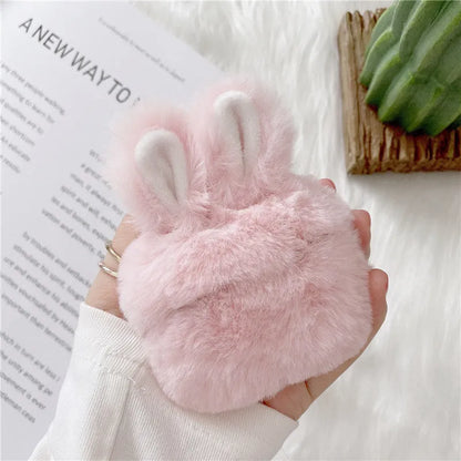 Pink silicone AirPods case cover with raised rabbit ears, placed next to grey version