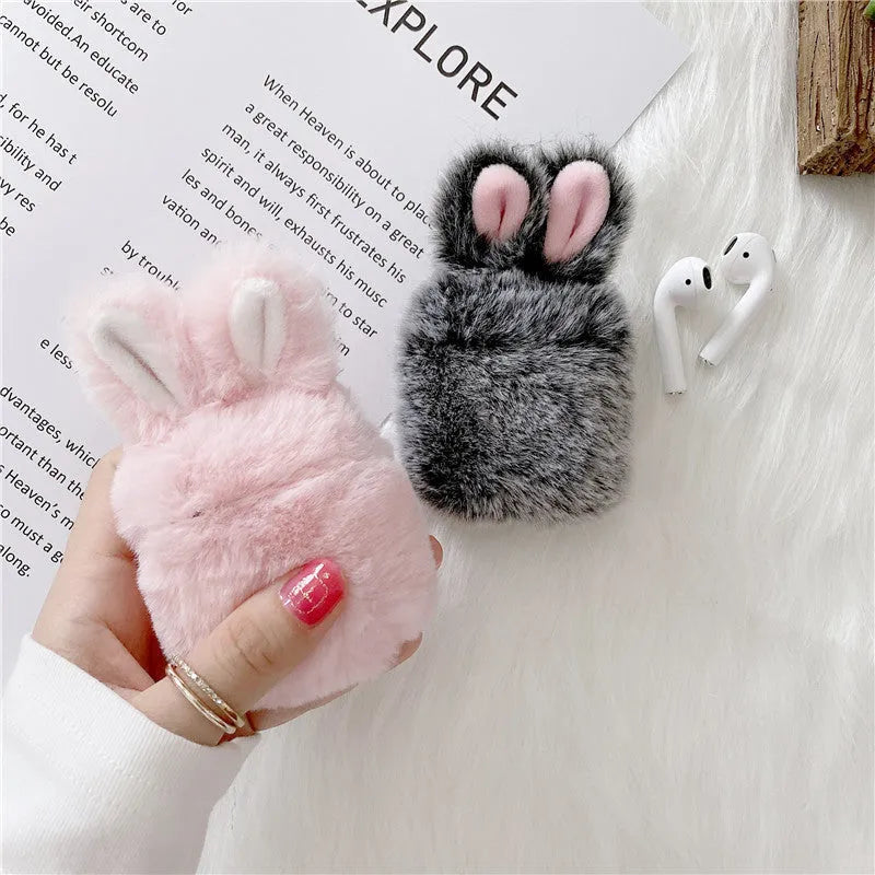 Pink silicone AirPods case cover with raised rabbit ears, placed next to grey version