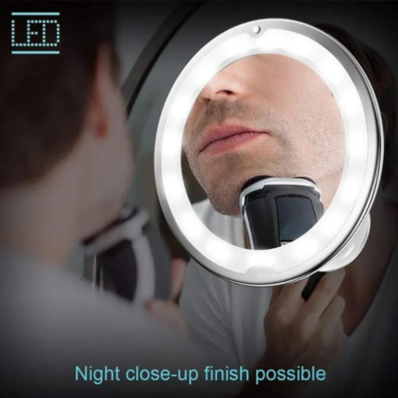 White 10x magnifying LED makeup mirror with flexible gooseneck and suction cup base on a table.
