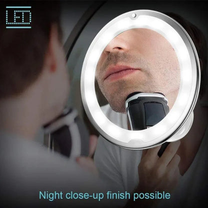 White 10x magnifying LED makeup mirror with flexible gooseneck and suction cup base on a table.