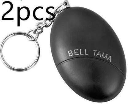 Compact black personal alarm keychain with pull-ring for loud siren activation, shown next to a ruler showing 6cm length.