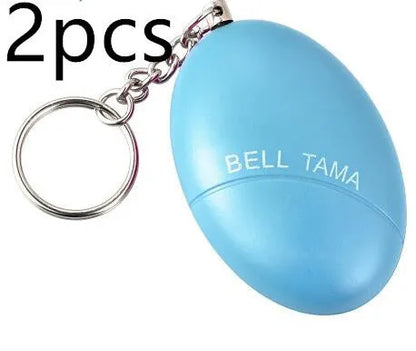 Compact black personal alarm keychain with pull-ring for loud siren activation, shown next to a ruler showing 6cm length.