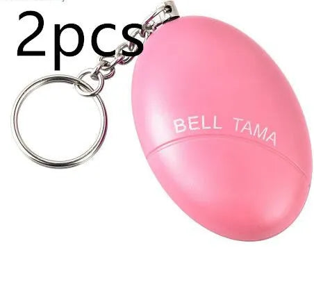 Compact black personal alarm keychain with pull-ring for loud siren activation, shown next to a ruler showing 6cm length.
