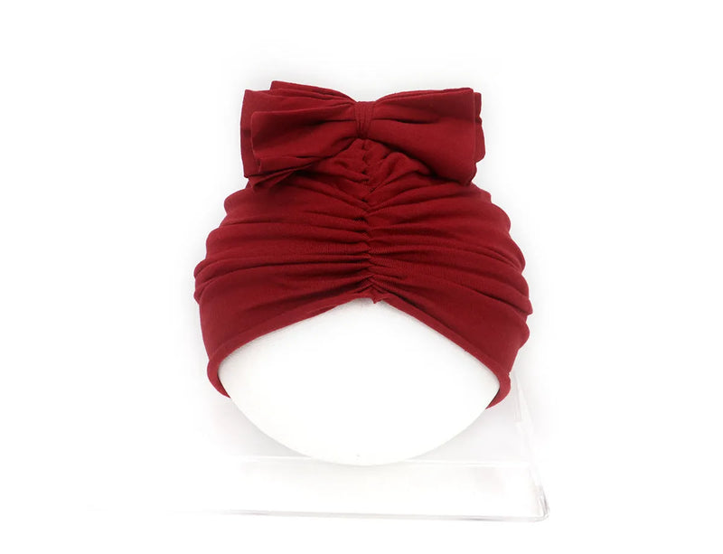 Baby girl hat in soft acrylic knitted fabric, newborn to toddler headwear cap turban bonnet with stretch fit for 0-28 months, available in nine solid colours including black, grey, pink, purple, red, white, wine red, yellow, and nude.