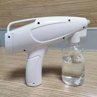 White handheld cordless electric spray disinfection gun with USB-C port and trigger, showing mist spray.