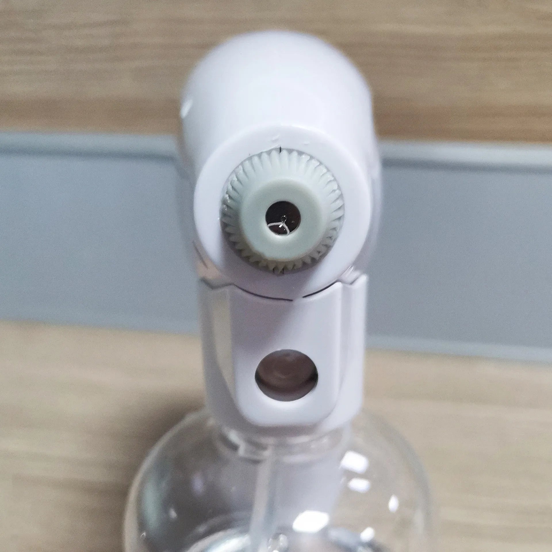 White handheld cordless electric spray disinfection gun with USB-C port and trigger, showing mist spray.