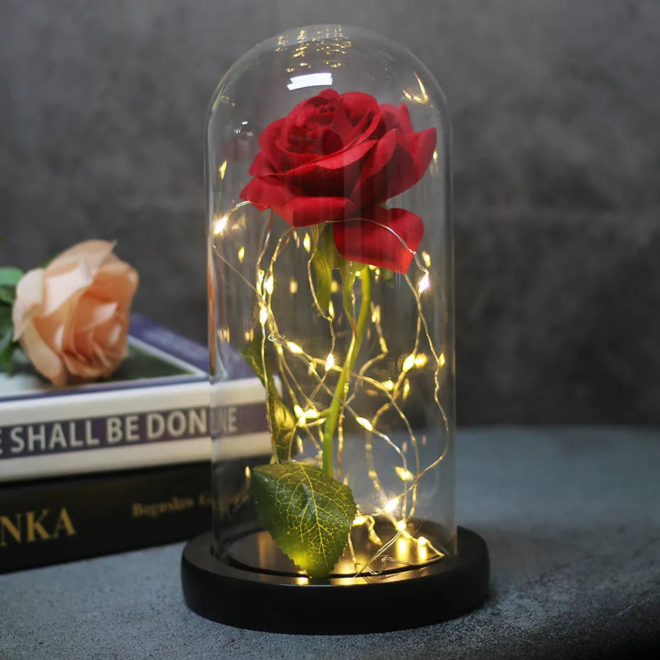LED simulation rose ornament with glass lampshade on a solid wood base, showing a choice of rose colours.