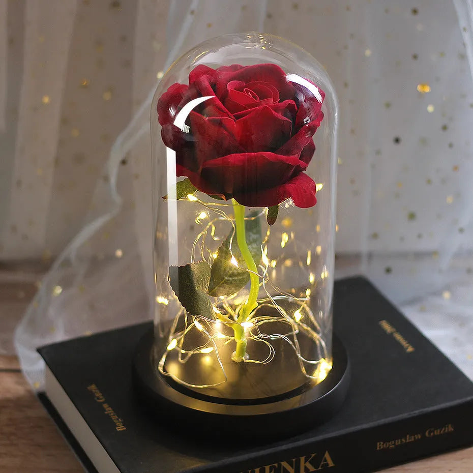 LED simulation rose ornament with glass lampshade on a solid wood base, showing a choice of rose colours.