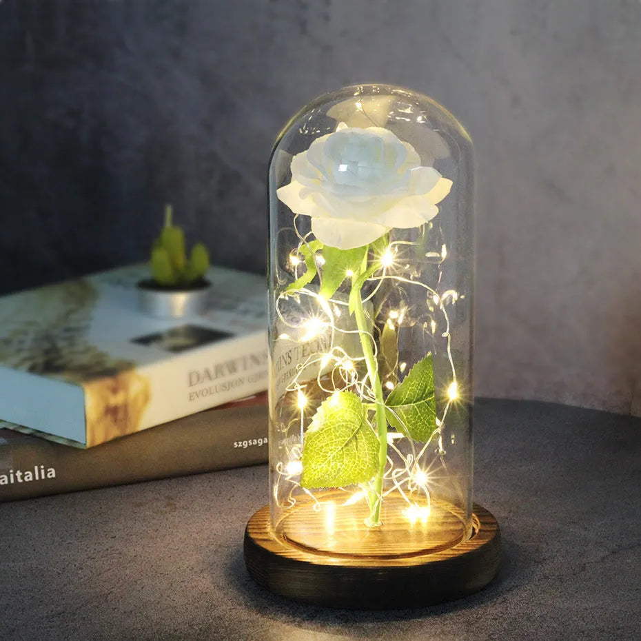LED simulation rose ornament with glass lampshade on a solid wood base, showing a choice of rose colours.