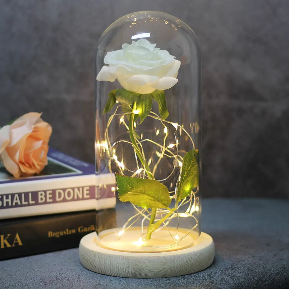 LED simulation rose ornament with glass lampshade on a solid wood base, showing a choice of rose colours.
