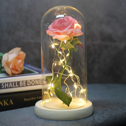 LED simulation rose ornament with glass lampshade on a solid wood base, showing a choice of rose colours.