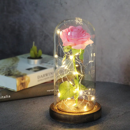 LED simulation rose ornament with glass lampshade on a solid wood base, showing a choice of rose colours.