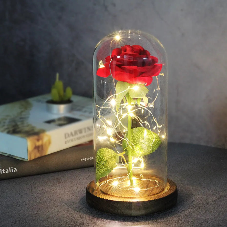 LED simulation rose ornament with glass lampshade on a solid wood base, showing a choice of rose colours.