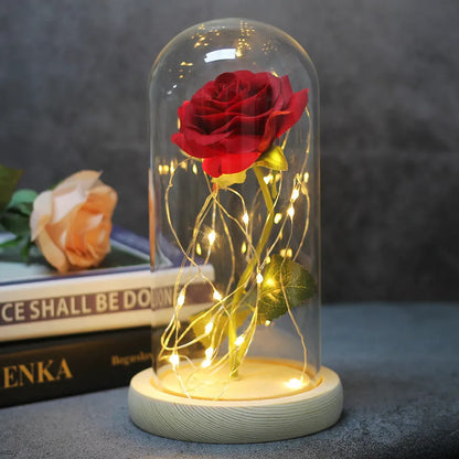 LED simulation rose ornament with glass lampshade on a solid wood base, showing a choice of rose colours.