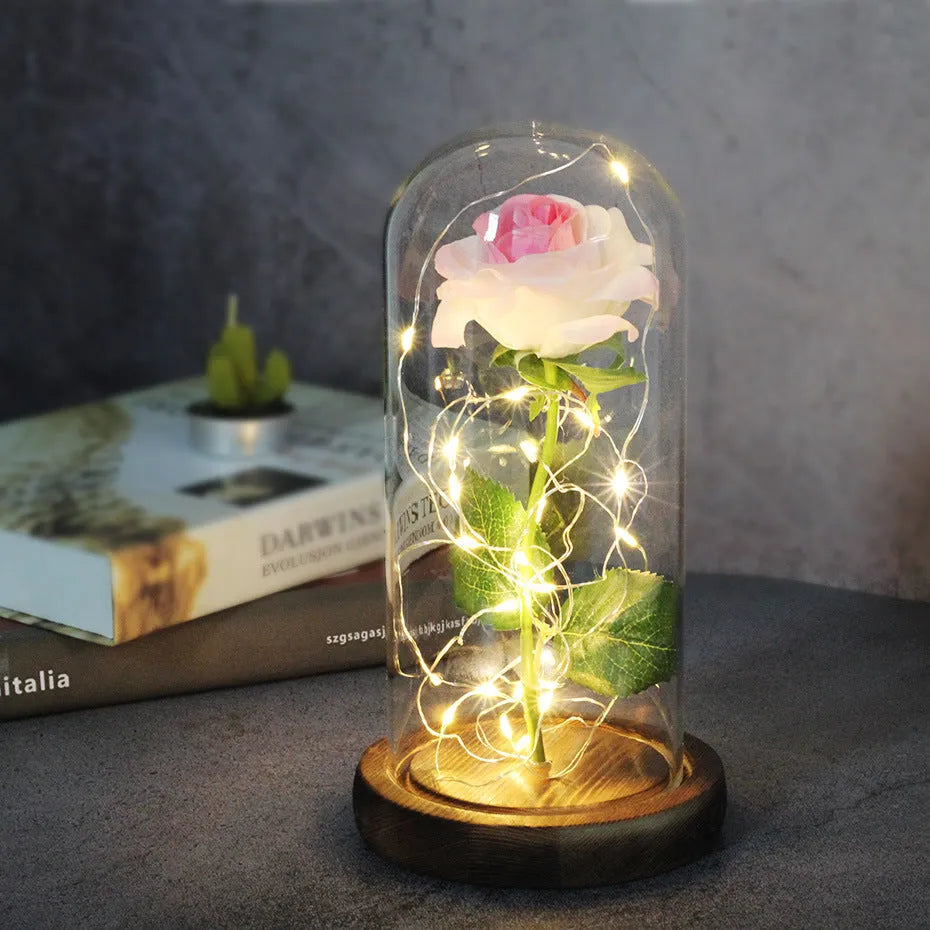 LED simulation rose ornament with glass lampshade on a solid wood base, showing a choice of rose colours.