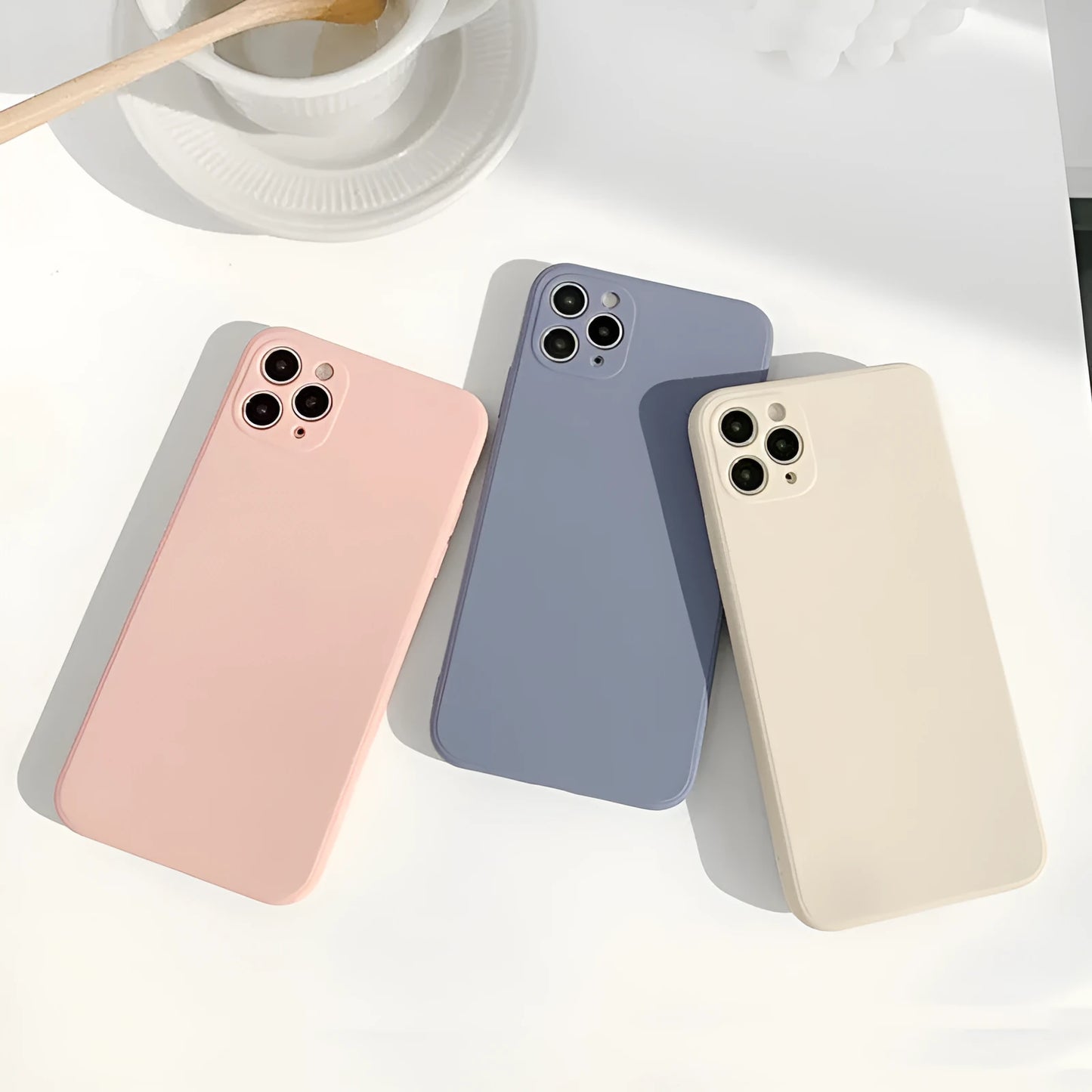 Solid colour silicone iPhone case in straight edge powder, slate blue and antique white options