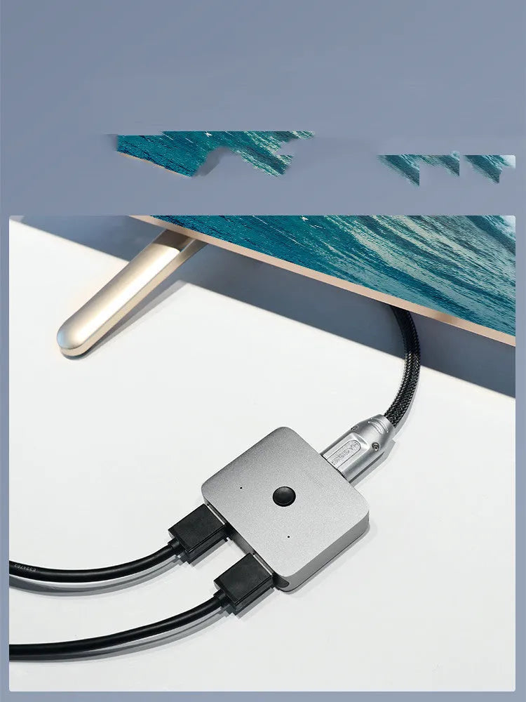 Grey Haibeisi HDMI switcher box with 2 input and 1 output ports for 4K video.