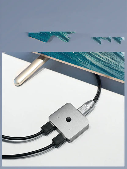 Grey Haibeisi HDMI switcher box with 2 input and 1 output ports for 4K video.