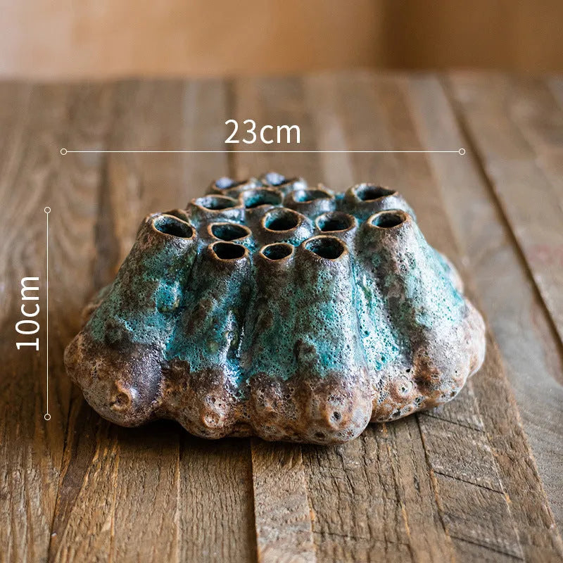Medium-sized ceramic Barnacle Vase with porous flower design in new Chinese style, on a table.