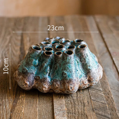 Medium-sized ceramic Barnacle Vase with porous flower design in new Chinese style, on a table.