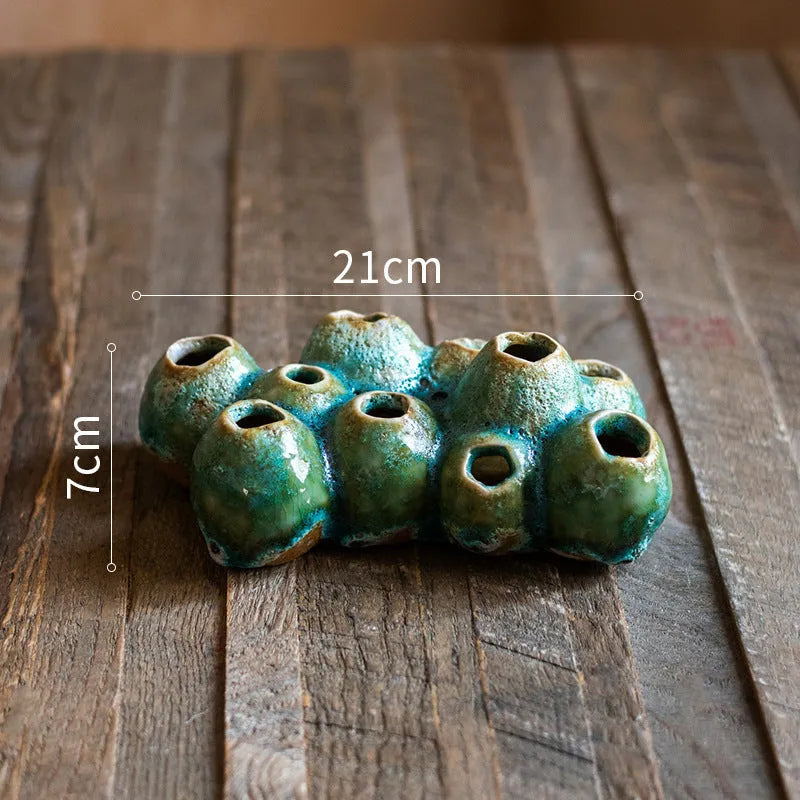Medium-sized ceramic Barnacle Vase with porous flower design in new Chinese style, on a table.