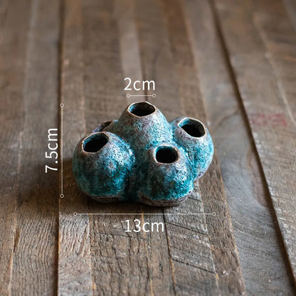 Medium-sized ceramic Barnacle Vase with porous flower design in new Chinese style, on a table.