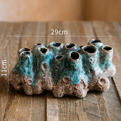 Medium-sized ceramic Barnacle Vase with porous flower design in new Chinese style, on a table.