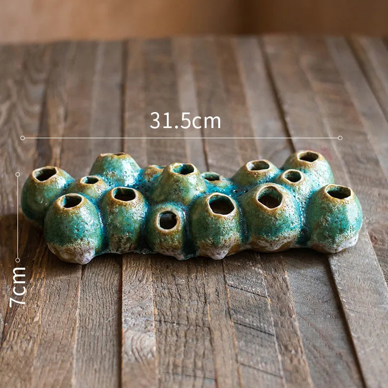 Medium-sized ceramic Barnacle Vase with porous flower design in new Chinese style, on a table.