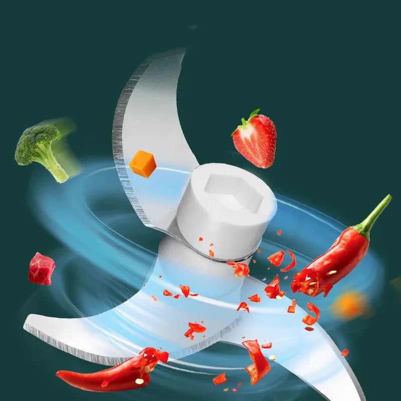 White portable electric food chopper with transparent cup and stainless steel blade on a kitchen counter.