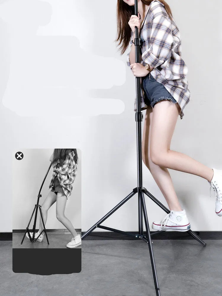 Carbon steel mobile phone tripod extended to full height with a 10-inch lamp attached and phone mounted.