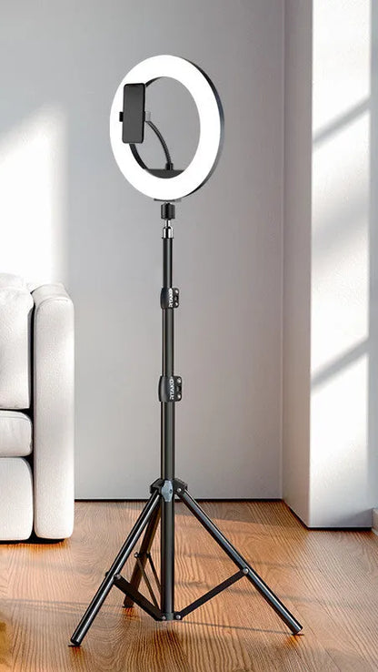 Carbon steel mobile phone tripod extended to full height with a 10-inch lamp attached and phone mounted.