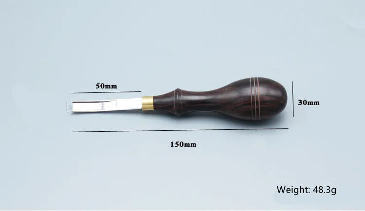 A leather-handled drum shovel wide shovel edge thinning knife on a workbench.