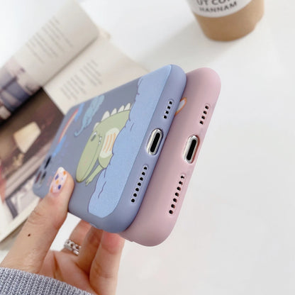 Blue frosted TPU iPhone case with a cartoon dinosaur print next to a pink case with a cat girl print.