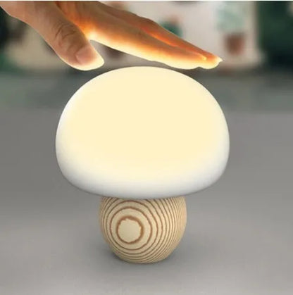White silicone mushroom-shaped LED night light with a wooden base and touch control.