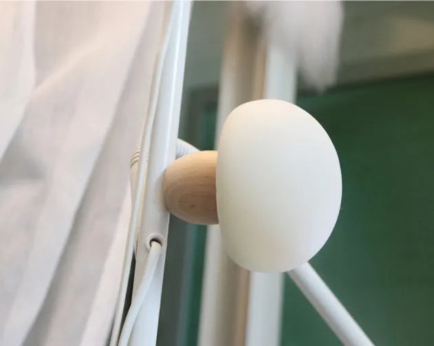White silicone mushroom-shaped LED night light with a wooden base and touch control.