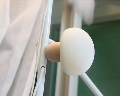 White silicone mushroom-shaped LED night light with a wooden base and touch control.