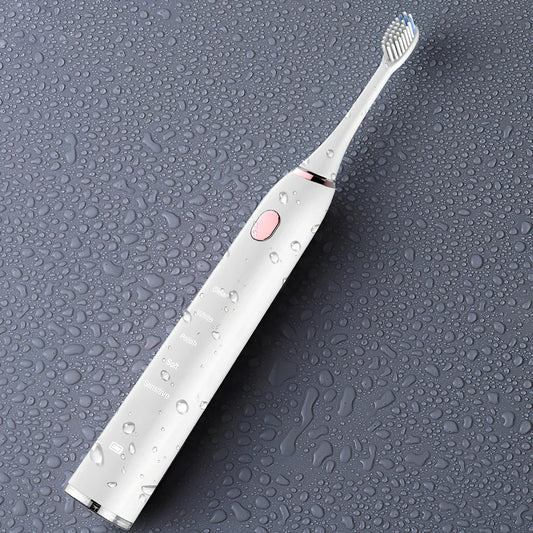 White waterproof electric toothbrush with inductive charging base and 5 nursing mode settings