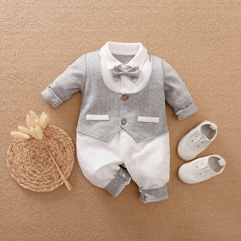 Baby boy in a navy blue long-sleeved cotton jumpsuit with a gentleman-style collar.