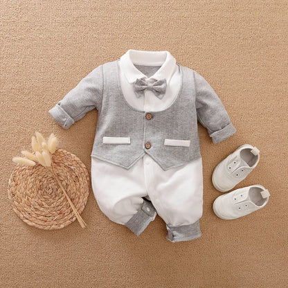Baby boy in a navy blue long-sleeved cotton jumpsuit with a gentleman-style collar.