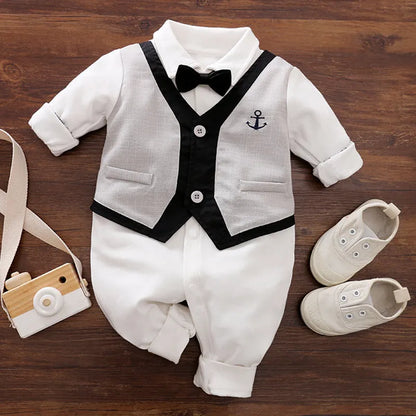 Baby boy in a navy blue long-sleeved cotton jumpsuit with a gentleman-style collar.