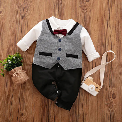 Baby boy in a navy blue long-sleeved cotton jumpsuit with a gentleman-style collar.