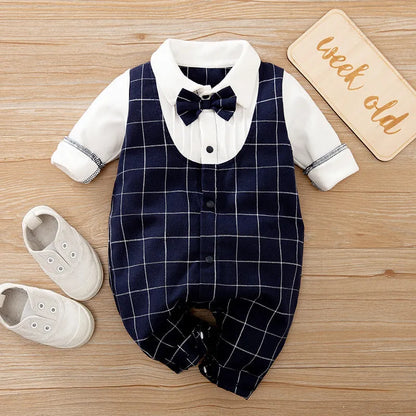 Baby boy in a navy blue long-sleeved cotton jumpsuit with a gentleman-style collar.