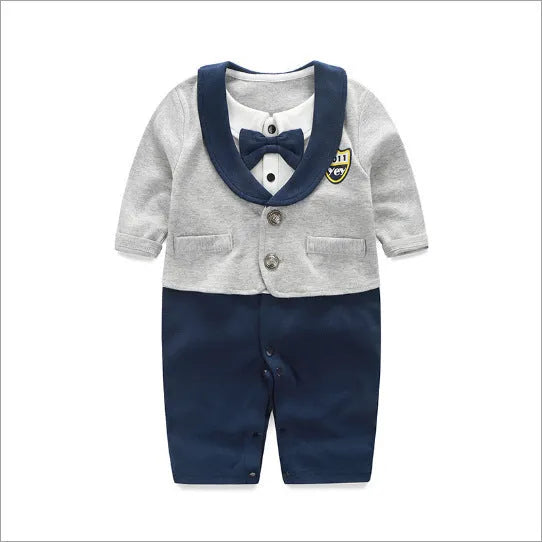 Baby boy in a navy blue long-sleeved cotton jumpsuit with a gentleman-style collar.
