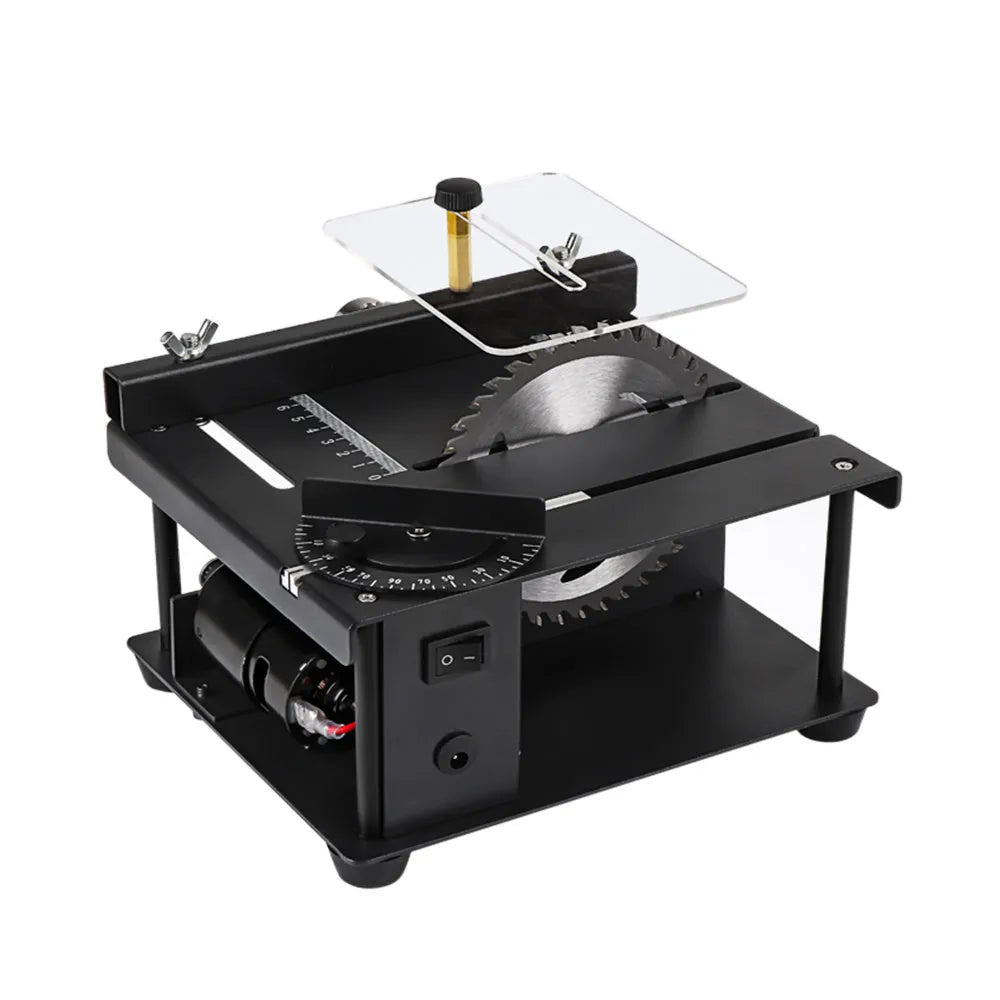Black miniature precision table saw on a workbench with sliding table and 110mm blade.