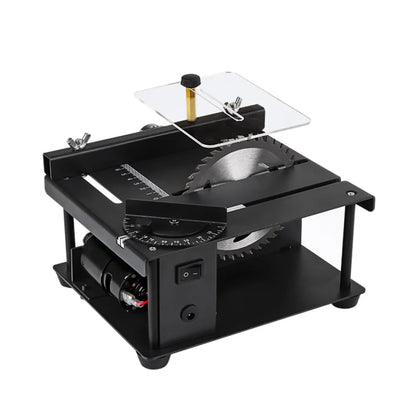 Black miniature precision table saw on a workbench with sliding table and 110mm blade.